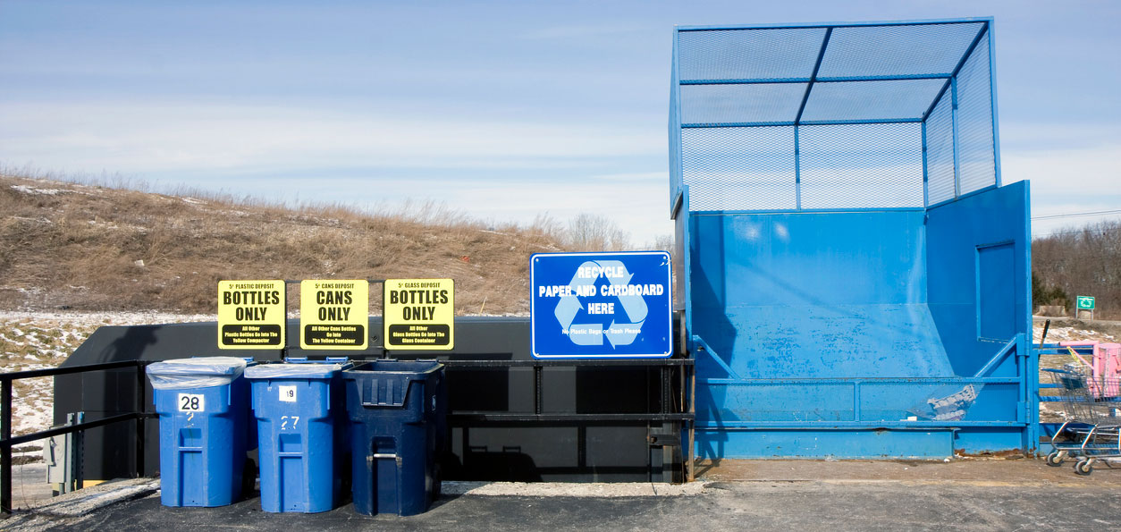 recycling bins by sand dunes