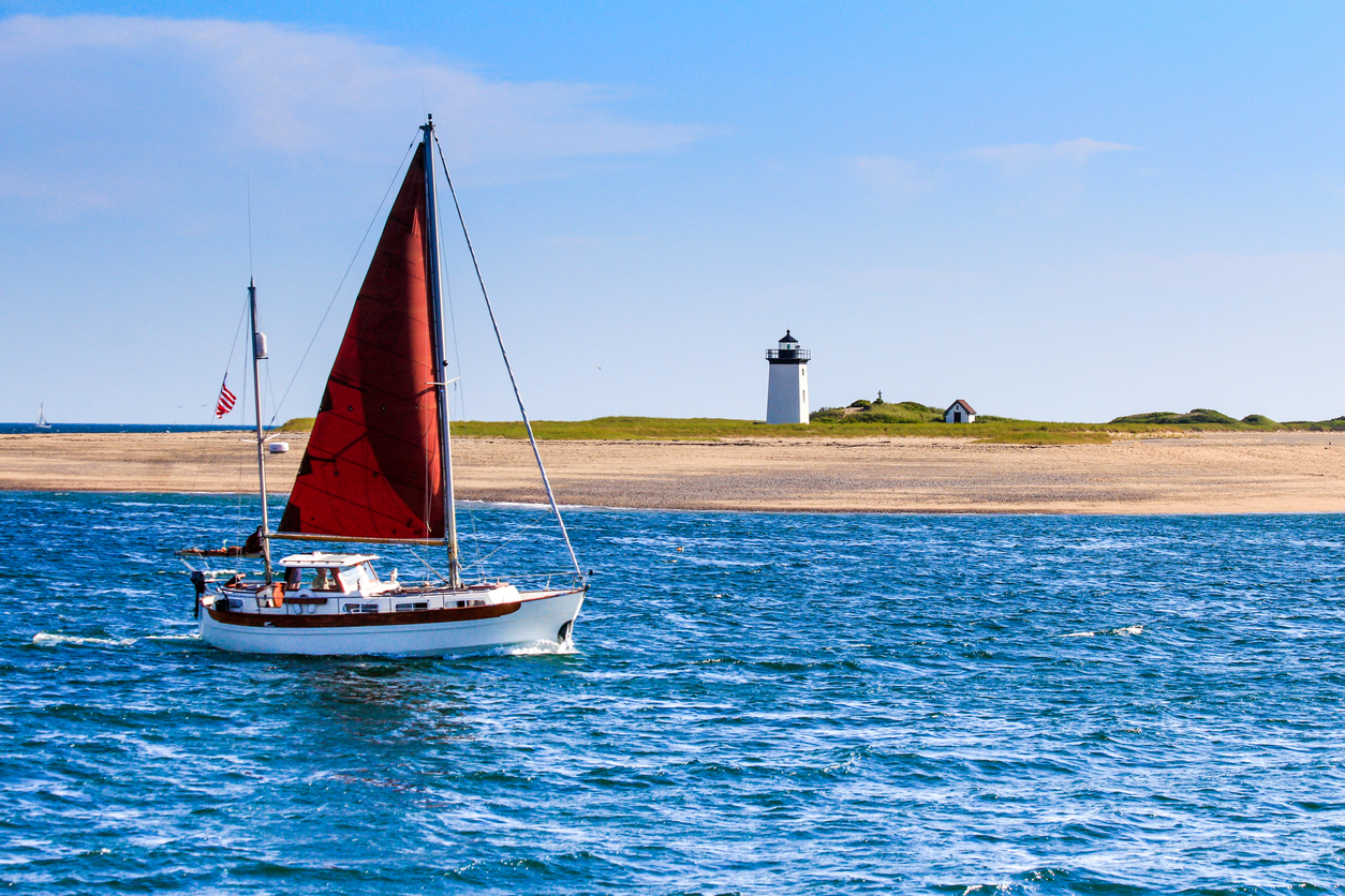 Yacht off a lighthouse